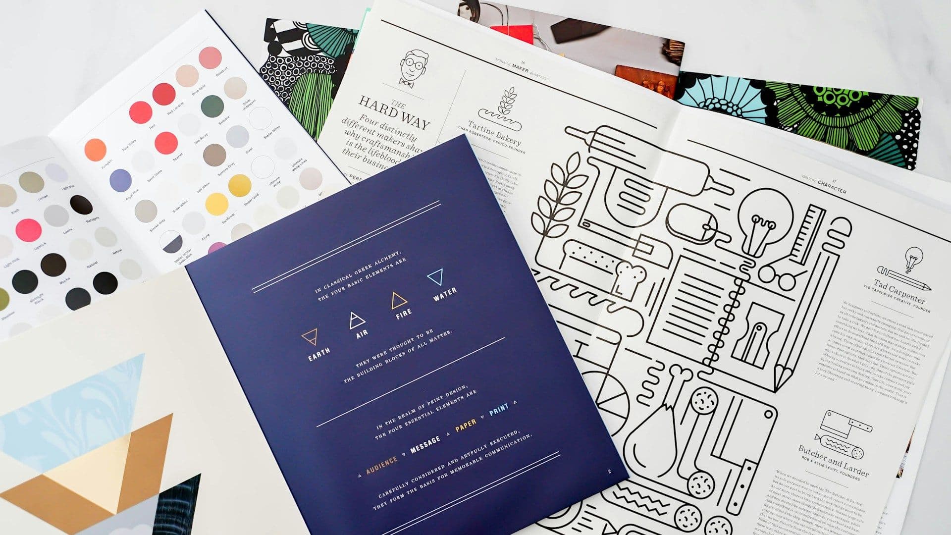 A bunch of papers with design inspiration are on a table.