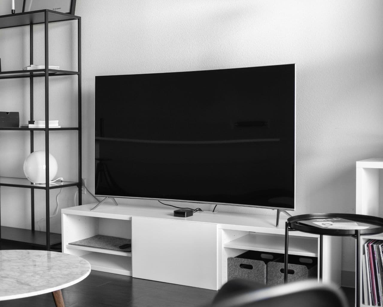 A television TV in a white minimalist living room.