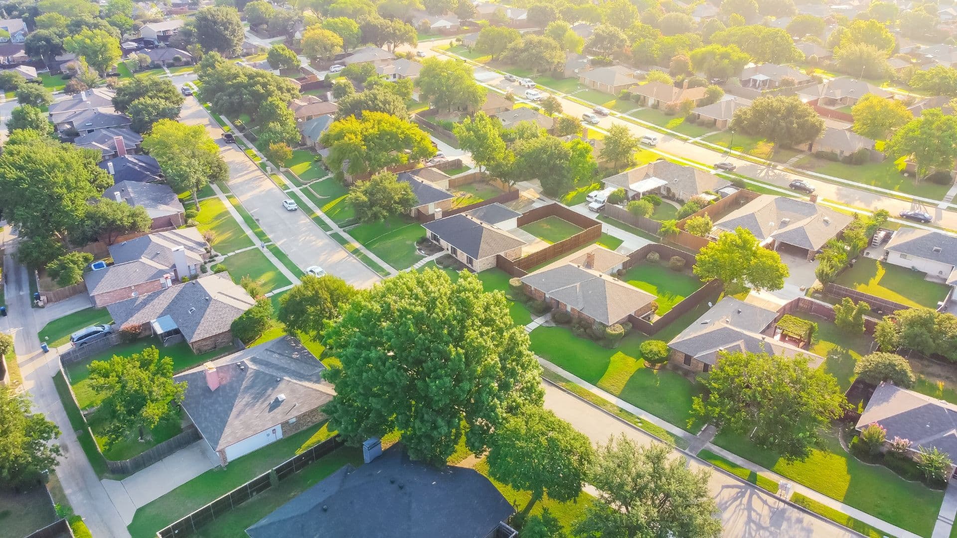 Bird eye view clean and peaceful neighborhood streets with row of single family homes.