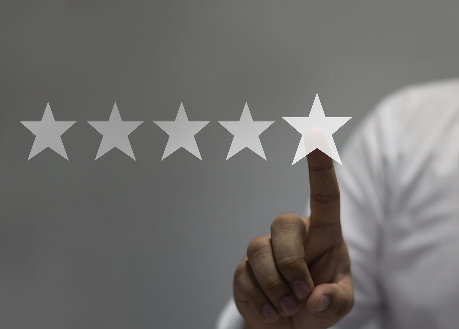 A person selects five stars.