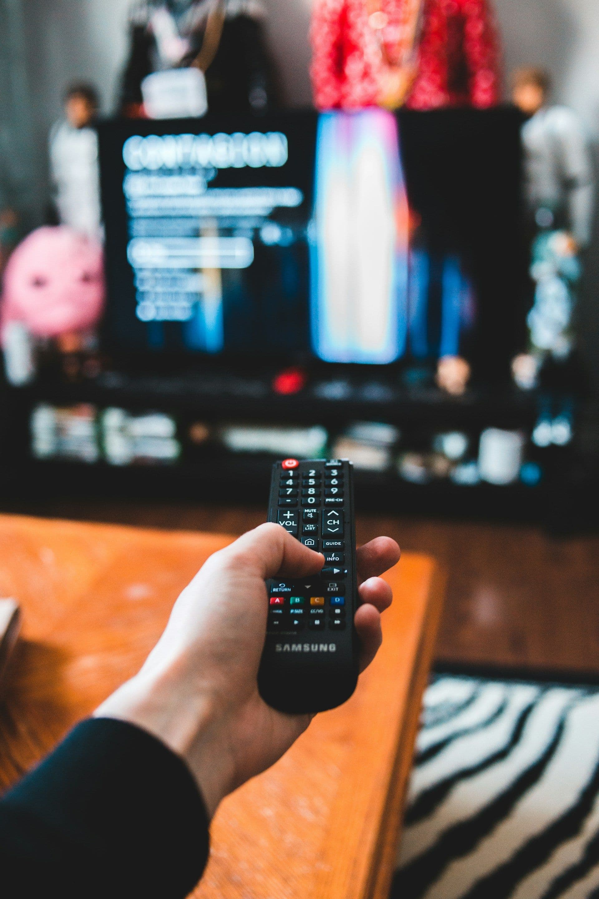 A person holds a TV remote.